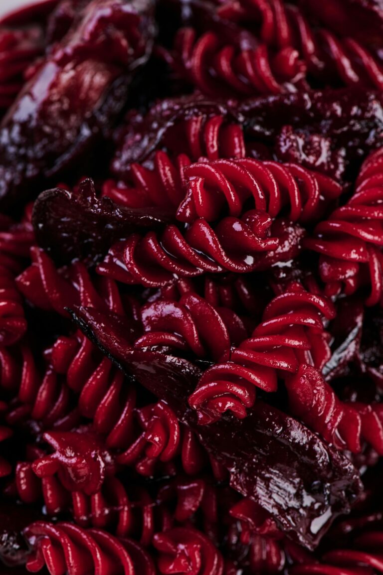 Close-up of vibrant red beet pasta highlighting its rich texture and color. Perfect for culinary enthusiasts.